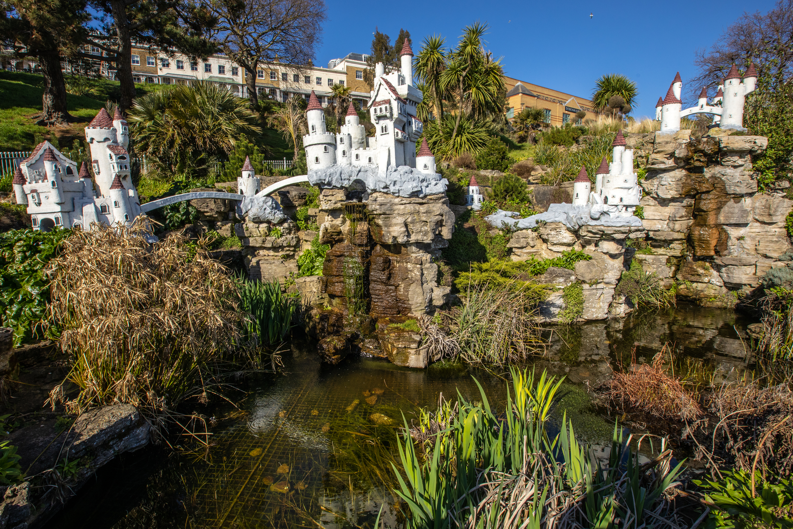 White fantasy castles and waterfalls in The Shrubbery, with The Palace Hotel Southend in the background.